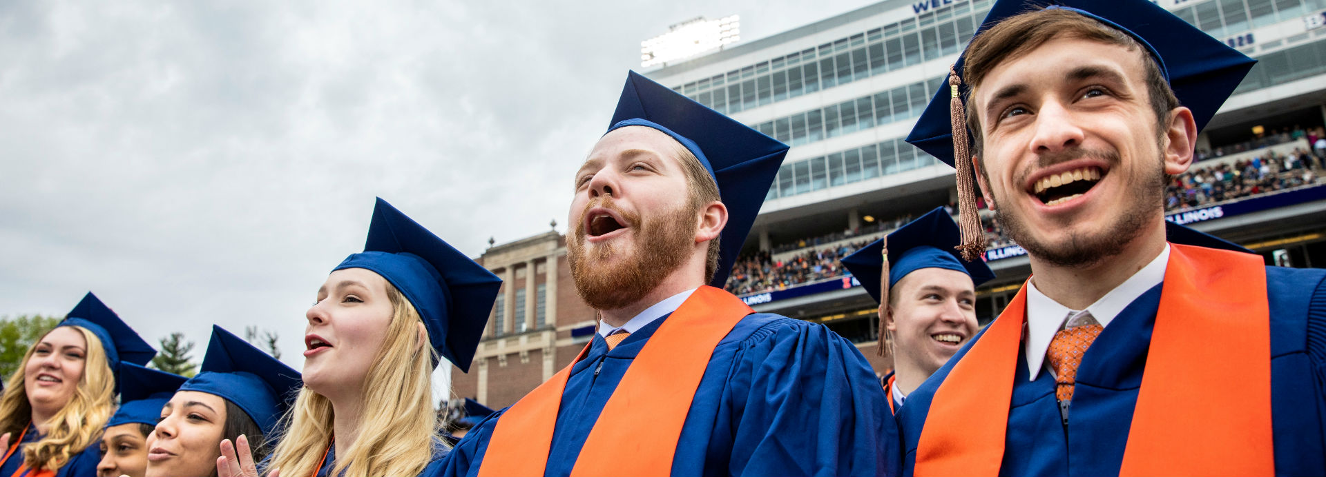 Graduates in their caps and gowns celebrate at Memorial Stadium during the commencement ceremony