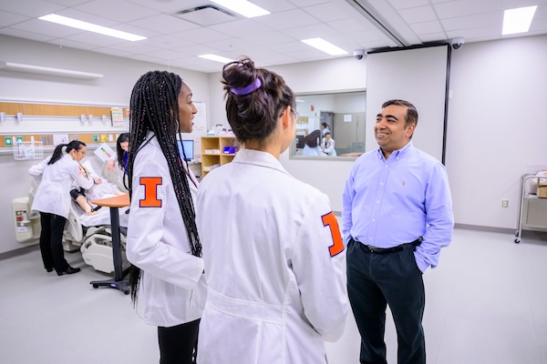 Carle Med students talking with professor