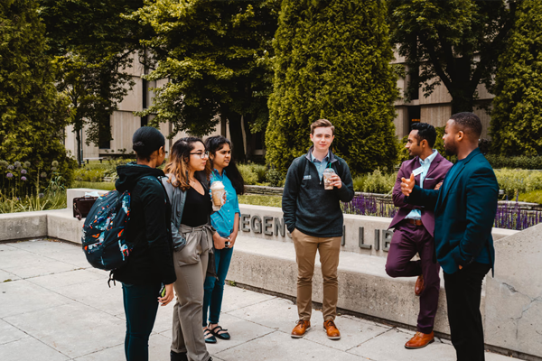 iVenture Students Talking in a Circle Outside with Coffee iVenture Students Talking in a Circle Outside with Coffee