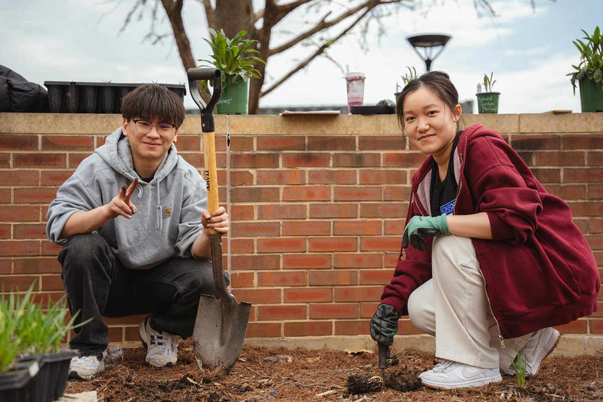 Students helping to landscape outside Wymer Hall