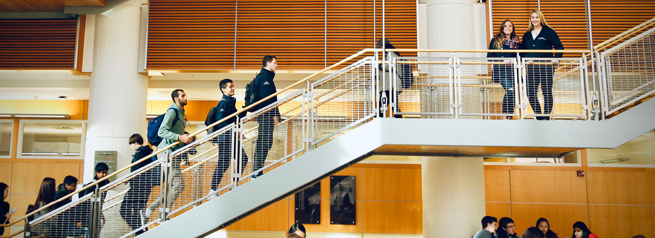 Students walking up an open staircase