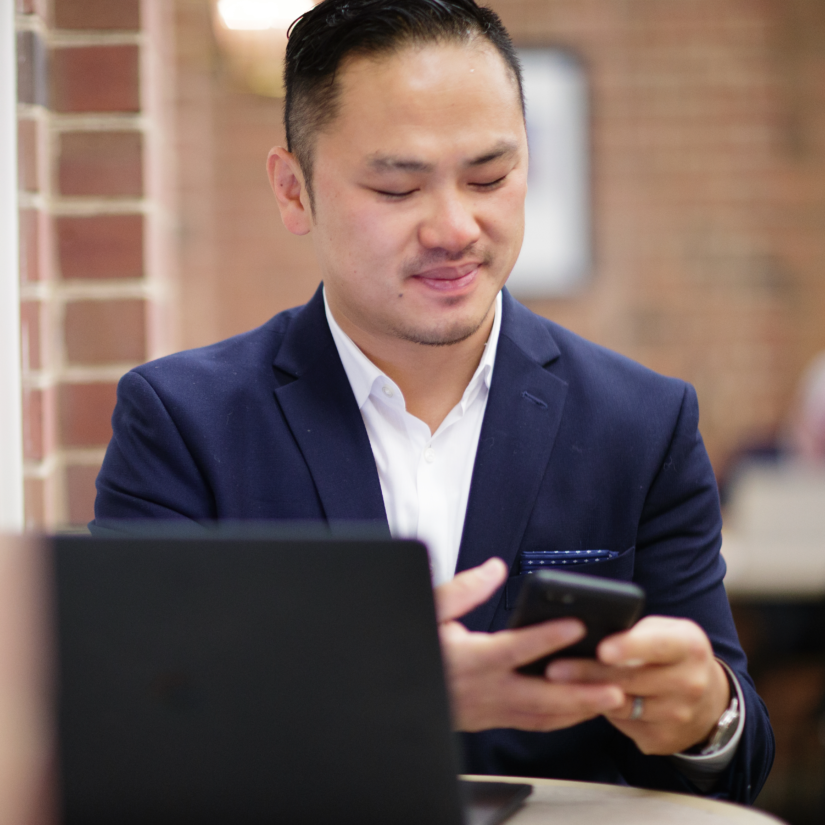 Student working on computer and phone