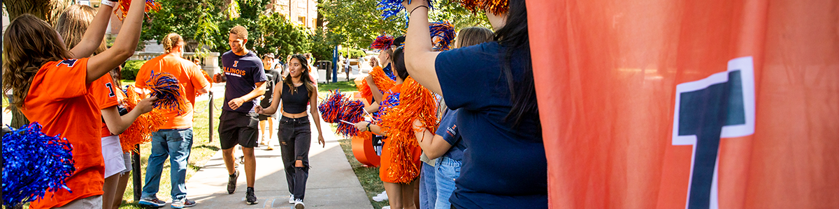 Two university students walking down a cheering line