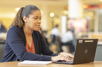 Marketing Management Course Highlight woman typing on laptop at table