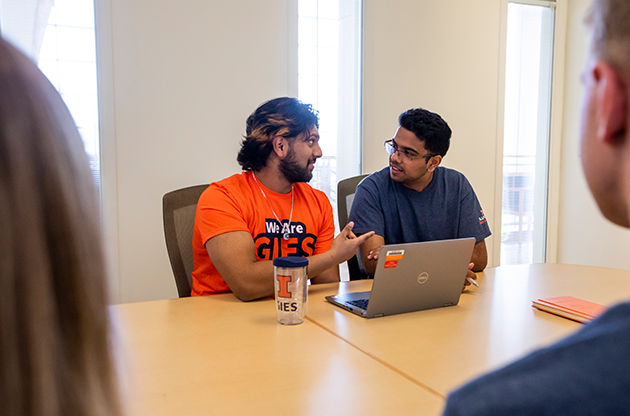 students discussing over laptop in BIF conference room