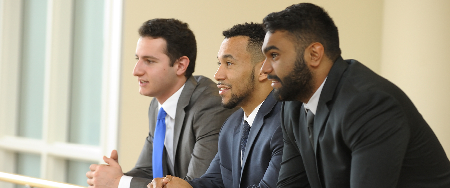 CTA Image for MBA Three male students in suits overlooking BIF atrium