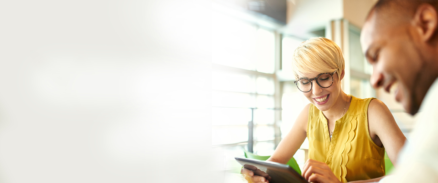 CTA Image for MSA Woman in yellow top looking at iPad in an open office space