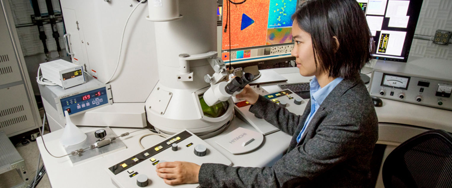 Woman in Science Technology Woman wearing blazer working at a microscope in lab
