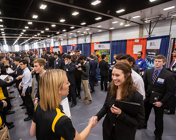 Business Career Fair Student shaking hand with recruiter at business career fair